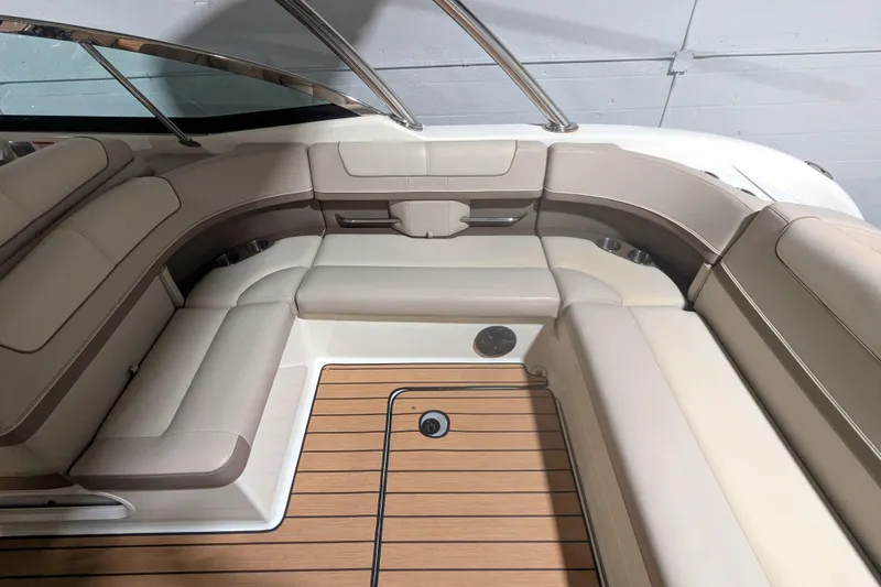Slide: The Image of 2014 Formula 350 Crossover Bowrider interior with beige seating and wood flooring. - 15