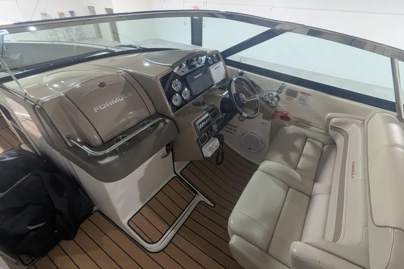Slide: The Image of 2014 Formula 350 Crossover Bowrider cockpit with steering wheel and dashboard controls. - 20