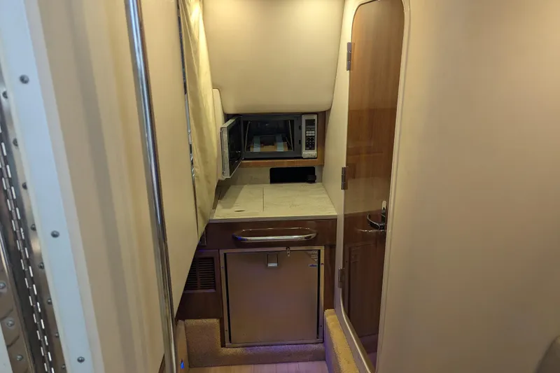 Slide: The Image of 2014 Formula 350 Crossover Bowrider cabin interior with kitchenette and microwave. - 21