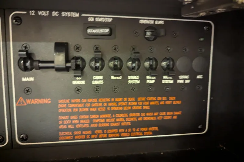 Slide: The Image of Control panel of a 2014 Formula 350 Crossover Bowrider, featuring 12V DC system switches. - 29