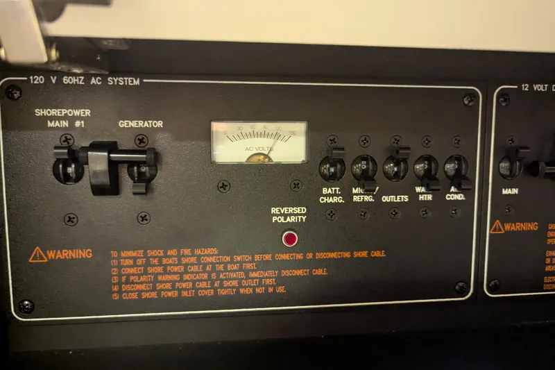 Slide: The Image of Control panel of a 2014 Formula 350 Crossover Bowrider, showing AC system and warnings. - 30