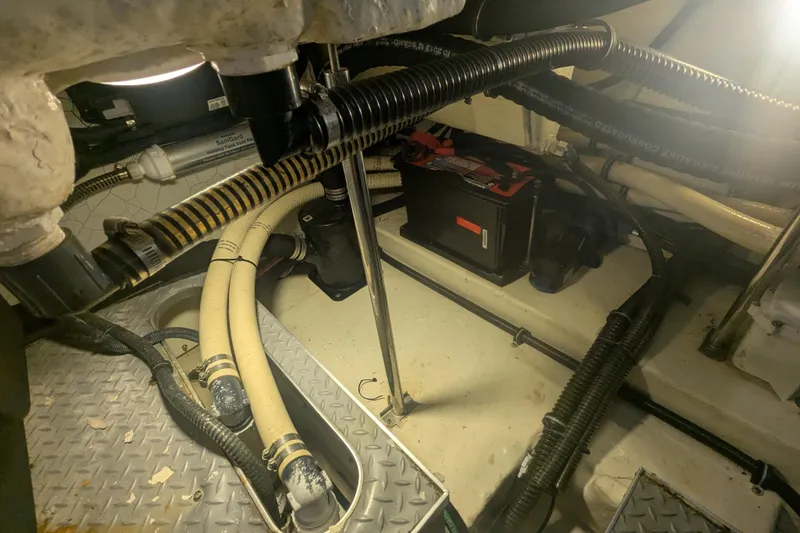 Slide: The Image of Engine compartment of a 2014 Formula 350 Crossover Bowrider with visible hoses and battery. - 41