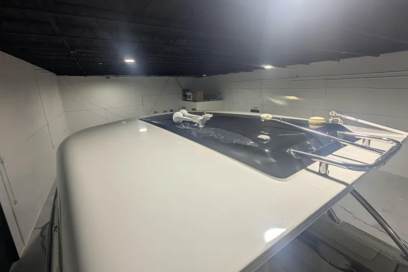 Slide: The Image of 2014 Formula 350 Crossover Bowrider in a dimly lit indoor storage. - 42
