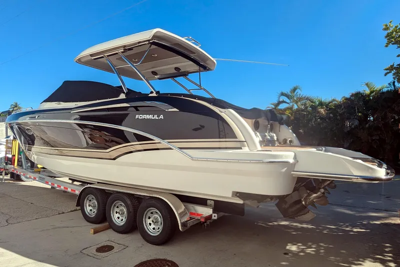Slide: The Image of 2014 Formula 350 Crossover Bowrider on trailer, sleek design, sunny day. - 47