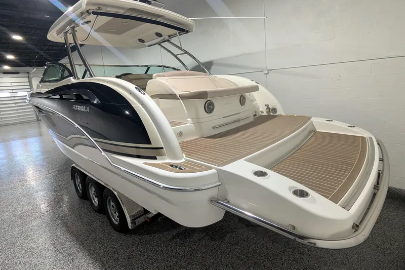 Slide: The Image of 2014 Formula 350 Crossover Bowrider in showroom, featuring sleek design and spacious deck. - 7