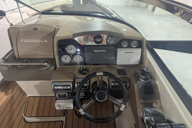 Slide: The Image of 2014 Formula 350 Crossover Bowrider dashboard with steering wheel and navigation controls. - 8