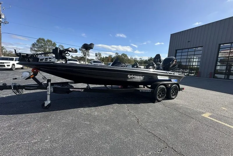 Slide: The Image of 2026 Phoenix 920 Elite X boat on trailer, parked outdoors under clear sky. - 6