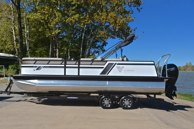 Slide: The Image of 2023 Viaggio Lago 22 R pontoon boat on trailer by a lake. - 11