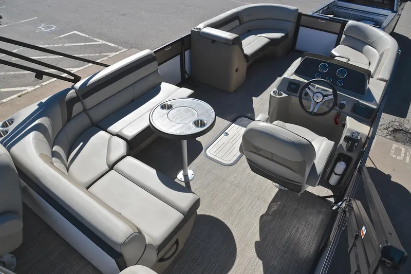 Slide: The Image of 2023 Viaggio Lago 22 R pontoon boat interior with plush seating and modern helm. - 19