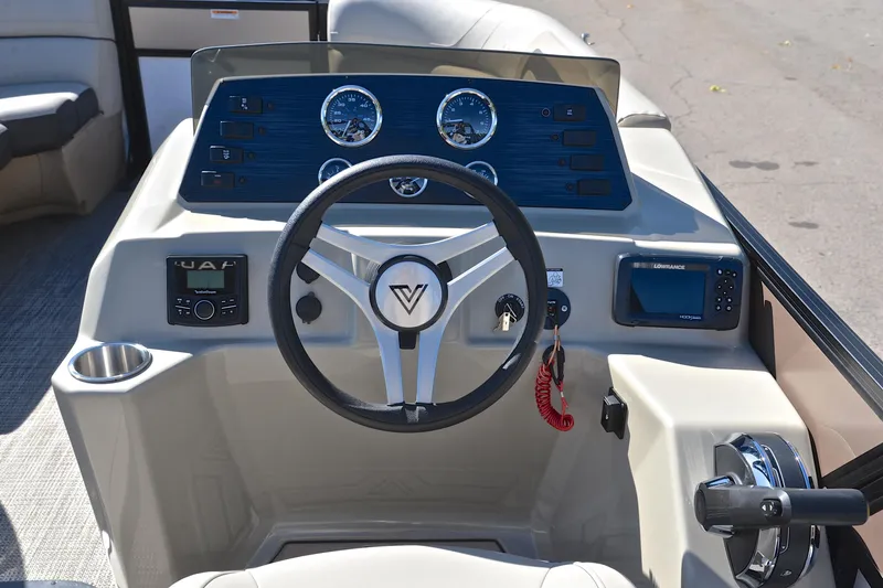 Slide: The Image of 2023 Viaggio Lago 22 R boat dashboard with steering wheel and navigation controls. - 26