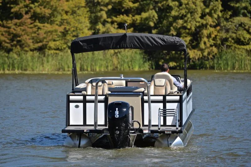 Slide: The Image of 2023 Viaggio Lago 22 R pontoon boat cruising on a lake with lush greenery. - 7
