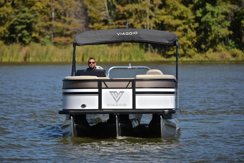 Slide: The Image of 2023 Viaggio Lago 22 R pontoon boat cruising on a serene lake. - 9