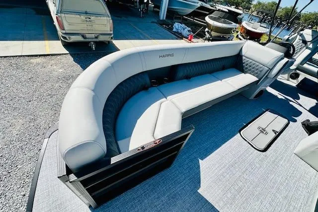 Slide: The Image of 2025 Harris Cruiser 250 pontoon boat with spacious seating, docked at a marina. - 10