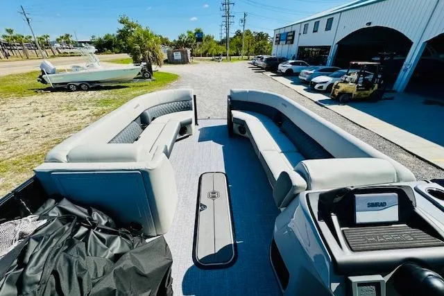 Slide: The Image of 2025 Harris Cruiser 250 pontoon boat with spacious seating and modern design. - 12