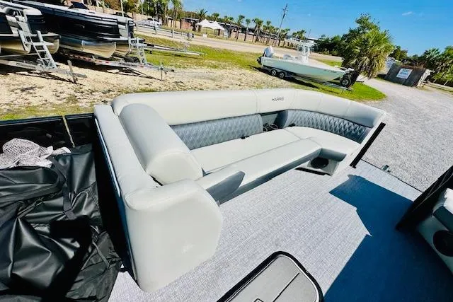 Slide: The Image of 2025 Harris Cruiser 250 pontoon boat with luxurious seating on a sunny day. - 13