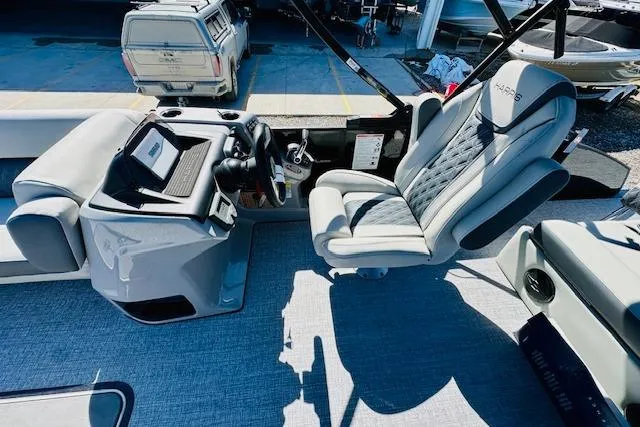 Slide: The Image of 2025 Harris Cruiser 250 boat interior with modern helm and luxurious seating. - 14