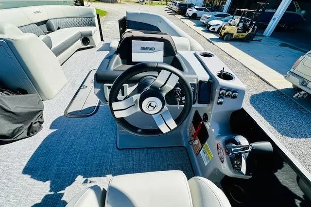 Slide: The Image of 2025 Harris Cruiser 250 boat interior with steering wheel and control panel. - 15