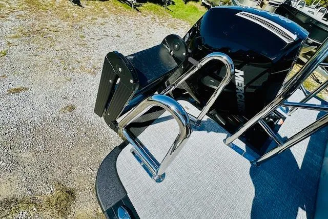 Slide: The Image of 2025 Harris Cruiser 250 boat with Mercury engine and stainless steel ladder. - 19