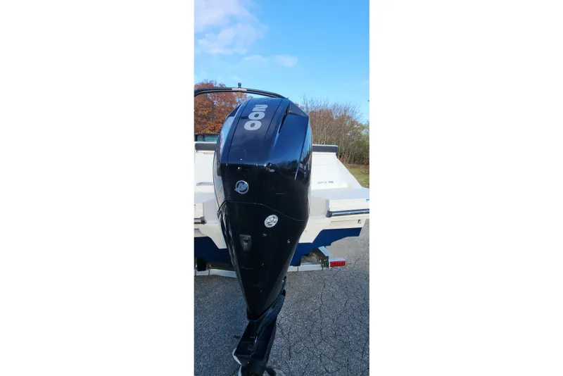 Slide: The Image of 2021 Sea Ray SPX 230 Outboard with powerful 200 HP engine, parked outdoors. - 13