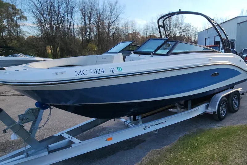 Slide: The Image of 2021 Sea Ray SPX 230 Outboard boat on trailer, blue and white design. - 15