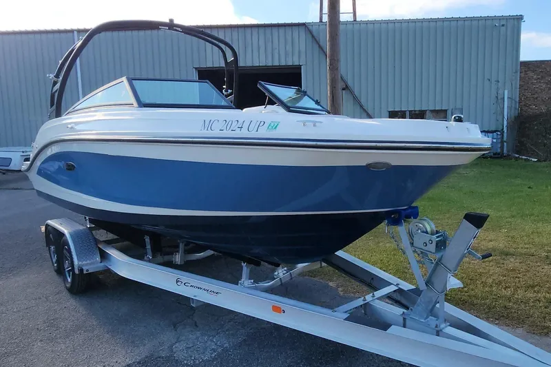 Slide: The Image of 2021 Sea Ray SPX 230 Outboard boat on trailer, blue and white exterior, parked outdoors. - 16