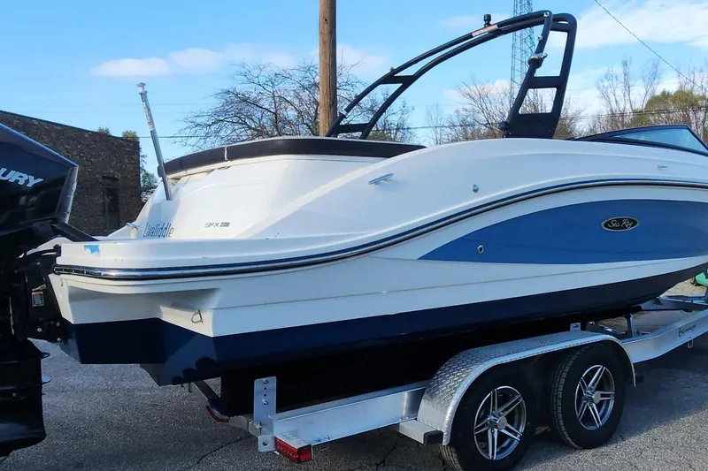 Slide: The Image of 2021 Sea Ray SPX 230 Outboard boat on trailer, side view. - 17