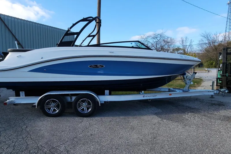 Slide: The Image of 2021 Sea Ray SPX 230 Outboard boat on trailer, parked outdoors. - 20