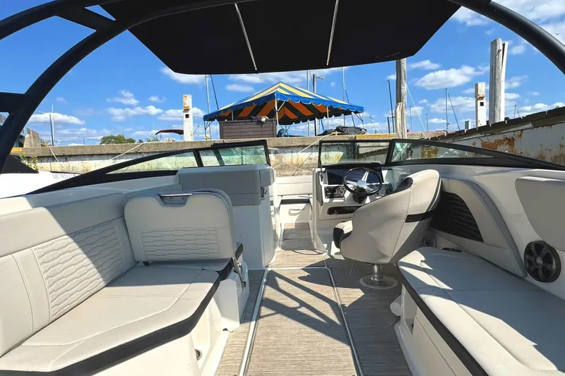 Slide: The Image of 2021 Sea Ray SPX 230 Outboard boat interior with seating and steering wheel. - 3