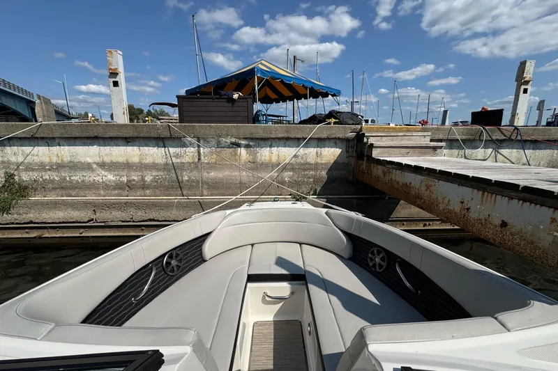 Slide: The Image of 2021 Sea Ray SPX 230 Outboard boat docked at marina under blue sky. - 5