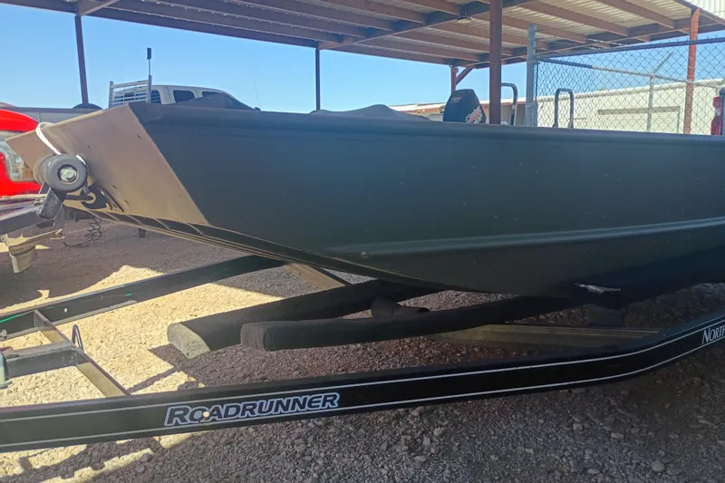 The Image of 2026 G3 1448 LW boat on Roadrunner trailer under a metal canopy. - 0