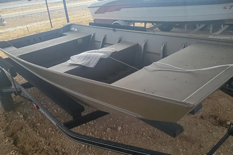 Slide: The Image of 2026 G3 1448 LW boat on trailer, displayed outdoors. - 3