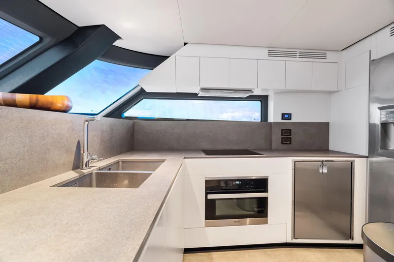 Slide: The Image of Modern kitchen interior on 2022 Azimut Magellano 25 Metri yacht, featuring sleek design and appliances. - 26