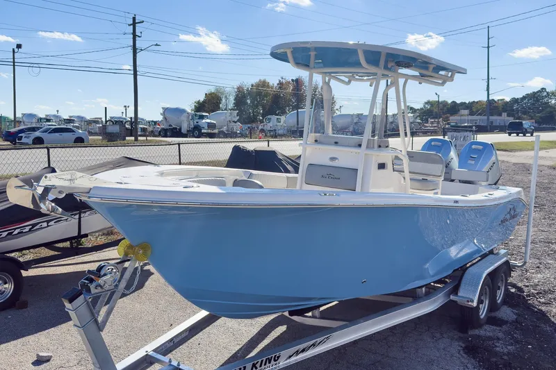 Slide: The Image of 2026 Sea Chaser 24 HFC DE boat on trailer, light blue hull, outdoor display. - 20