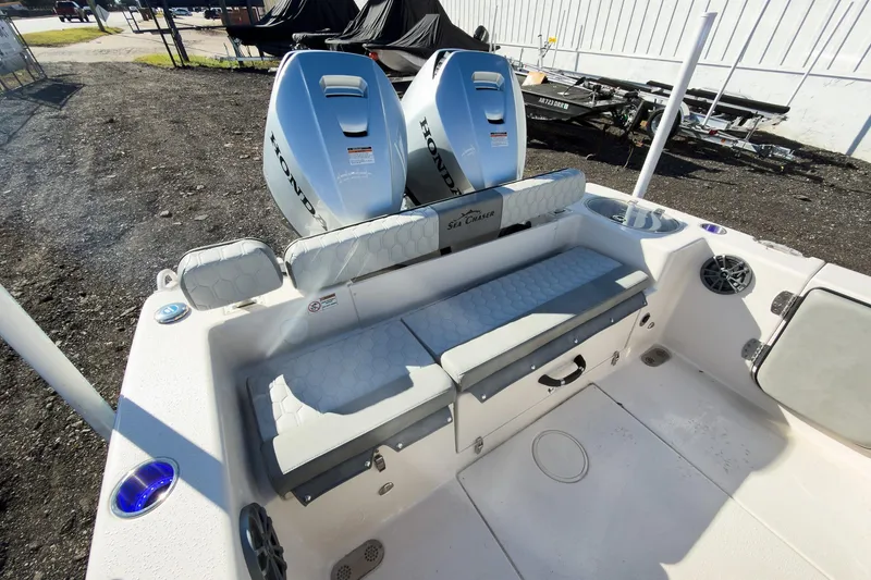 Slide: The Image of 2026 Sea Chaser 24 HFC DE boat with dual Honda engines and cushioned seating. - 23