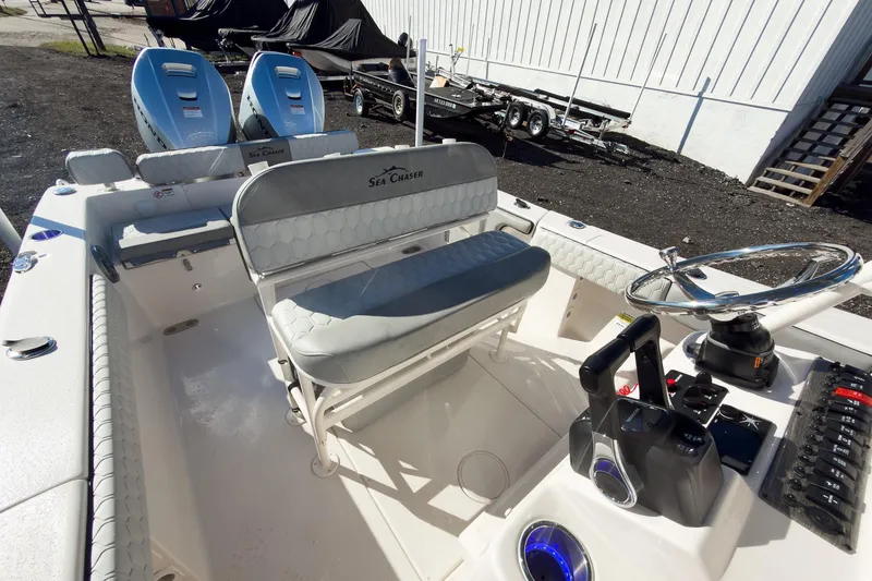 Slide: The Image of 2026 Sea Chaser 24 HFC DE boat interior with helm and seating area. - 24