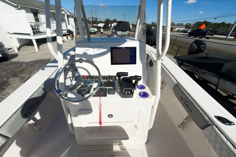 Slide: The Image of 2026 Sea Chaser 24 HFC DE boat console with steering wheel and navigation display. - 27