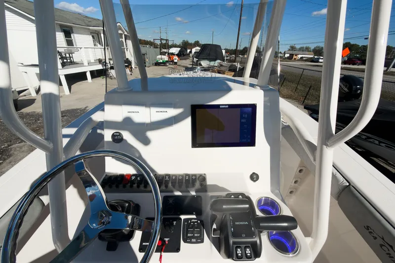 Slide: The Image of 2026 Sea Chaser 24 HFC DE boat dashboard with steering wheel and control panel. - 28