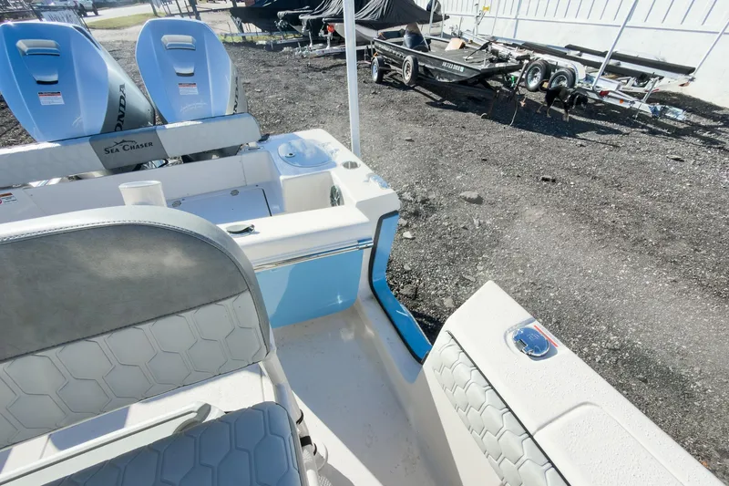 Slide: The Image of 2026 Sea Chaser 24 HFC DE boat interior with seating and dual Honda engines. - 37