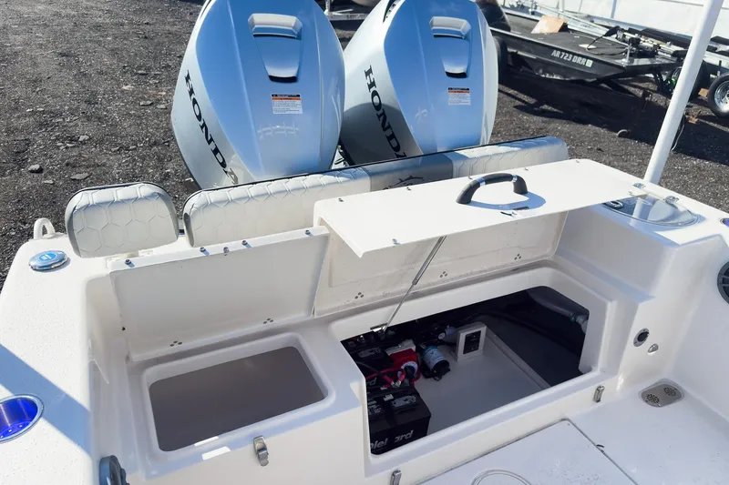 Slide: The Image of 2026 Sea Chaser 24 HFC DE boat with open storage compartment and dual Honda engines. - 39