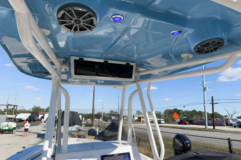 Slide: The Image of 2026 Sea Chaser 24 HFC DE boat with blue T-top and speakers. - 42