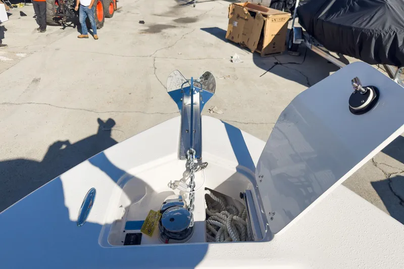 Slide: The Image of Bow anchor compartment of 2026 Sea Chaser 24 HFC DE boat, open with rope and anchor visible. - 48