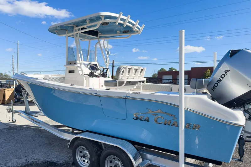 Slide: The Image of 2026 Sea Chaser 24 HFC DE boat on trailer, featuring Honda outboard motor. - 50