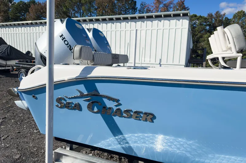 Slide: The Image of 2026 Sea Chaser 24 HFC DE boat with Honda engine, parked outdoors. - 53