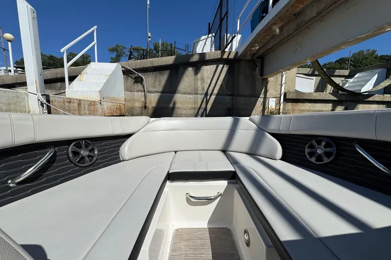 Slide: The Image of 2021 Sea Ray SPX 230 Outboard boat interior with cushioned seating and speakers. - 10