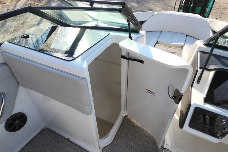 Slide: The Image of 2021 Sea Ray SPX 230 Outboard boat interior with open storage compartment. - 13