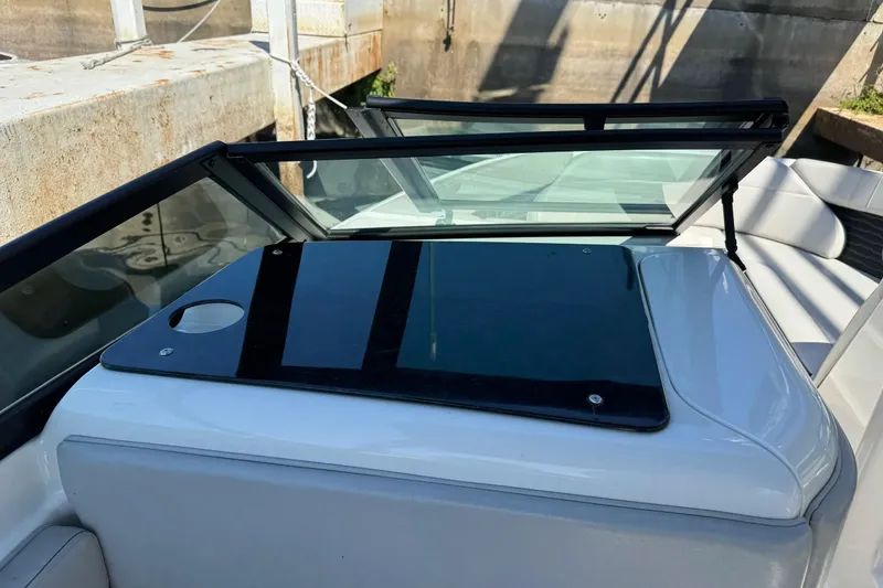 Slide: The Image of 2021 Sea Ray SPX 230 Outboard boat with sleek windshield and seating area. - 15