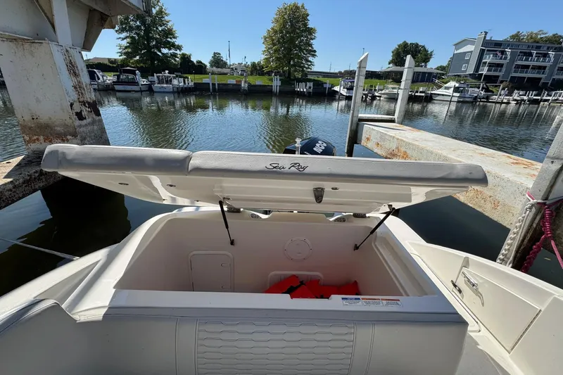 Slide: The Image of 2021 Sea Ray SPX 230 Outboard boat with open storage compartment at marina. - 19