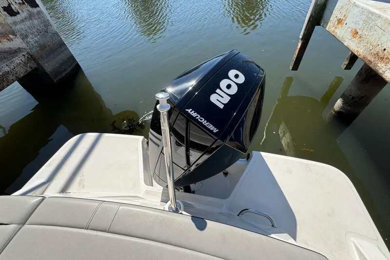 Slide: The Image of 2021 Sea Ray SPX 230 Outboard motor on calm water near dock. - 22
