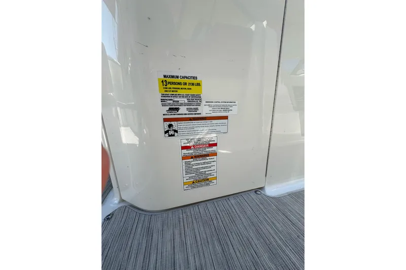 Slide: The Image of Capacity label on 2021 Sea Ray SPX 230 Outboard, indicating 13-person or 2135 lbs limit. - 24