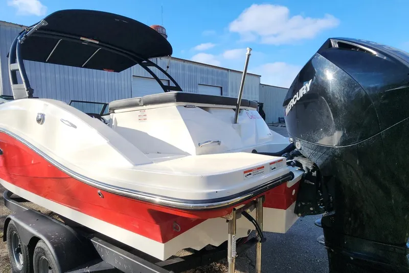 Slide: The Image of 2021 Sea Ray SPX 230 Outboard boat with Mercury engine, parked on a trailer. - 28
